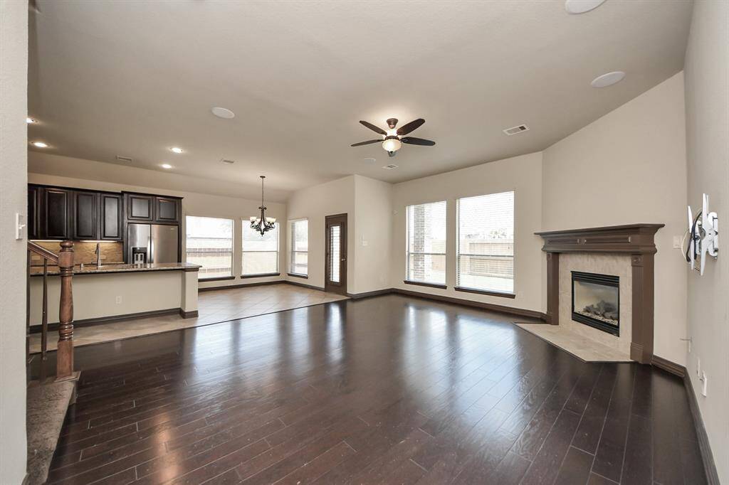 Open-concept living connects to the kitchen and backyard views.