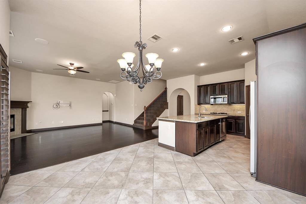 Elegant staircase leads to the second-floor retreat, perfectly placed next to the gourmet kitchen.