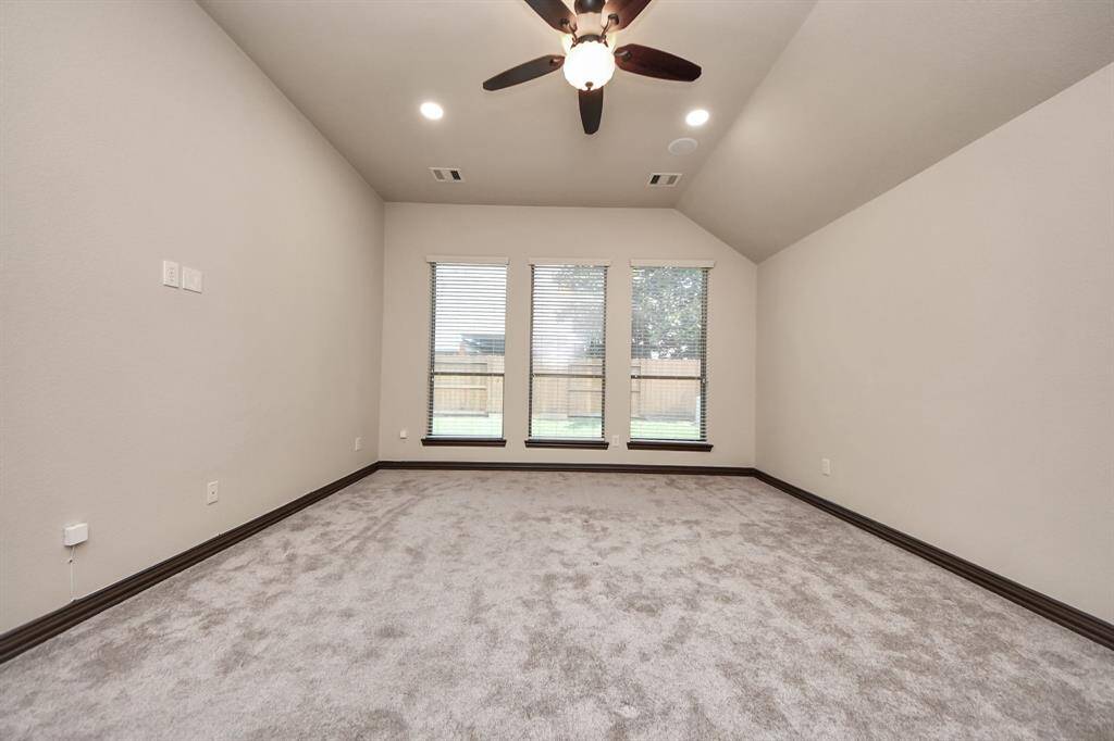 Soaring ceilings, modern recessed lighting, and serene backyard views.