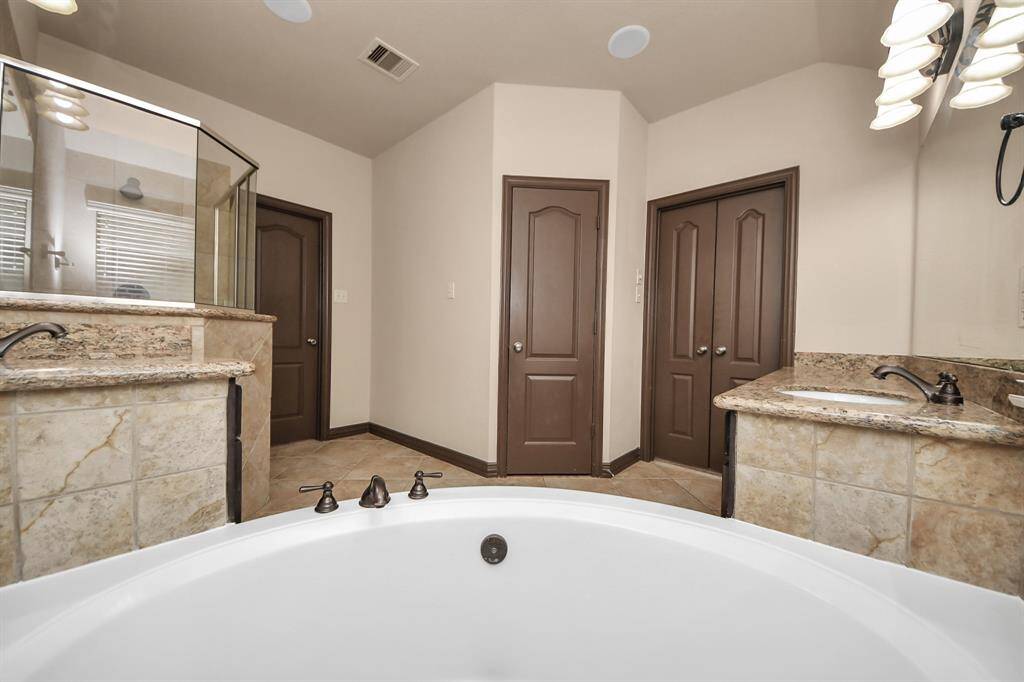 Dedicated laundry space with connecting door to the primary walk-in closet for ultimate convenience.
