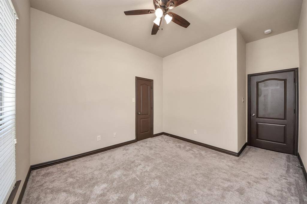 Fresh, neutral tones and ceiling fan comfort make this secondary bedroom move-in ready.