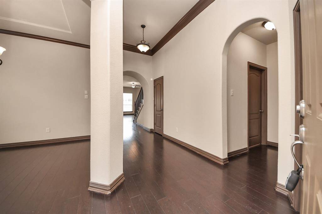 Step inside to soaring ceilings, rich wood floors, and elegant archways—your warm welcome home!