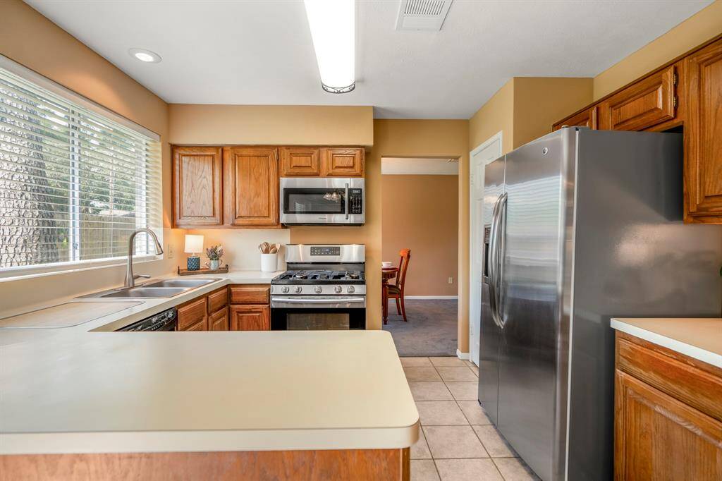 Bright, well-lit kitchen featuring natural light and has a view to the formal dining room.