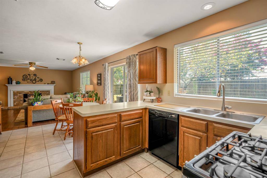 This is a warm and inviting open-plan kitchen connecting the living area creating a perfect environment for both cooking and socializing.