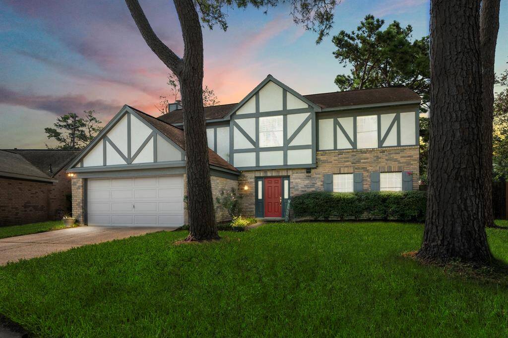 Lovely home nestled among mature trees at dusk, creating a serene and enchanting setting