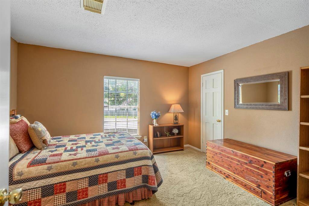 Secondary bedroom features a large walk-in closet
