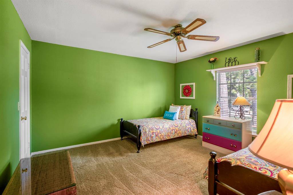 Large vibrant secondary bedroom with over-sized walk-in closet
