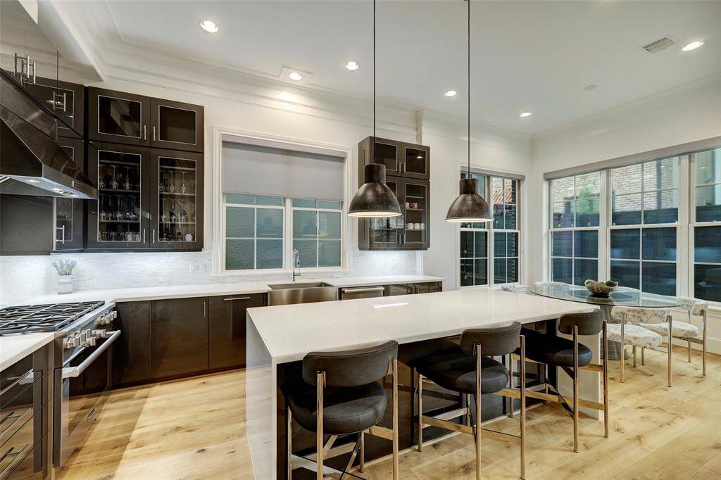Look at this kitchen! White marbe waterfall island and fabulous Eclipse glossy acrylic cabinetry with 3D aluminum edges
