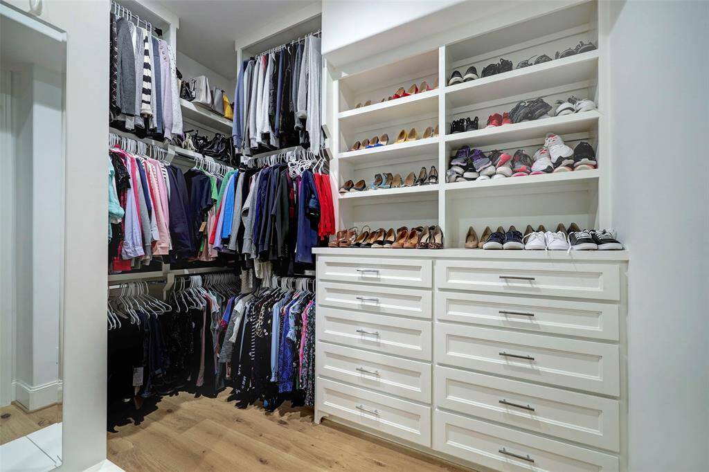 Closet has loads of built-ins and leads to the laundry room.