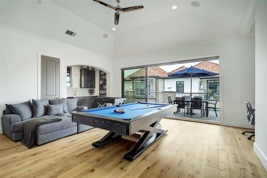Huge game room on third floor. It has another set of the stacking glass panels leading to the roof deck.