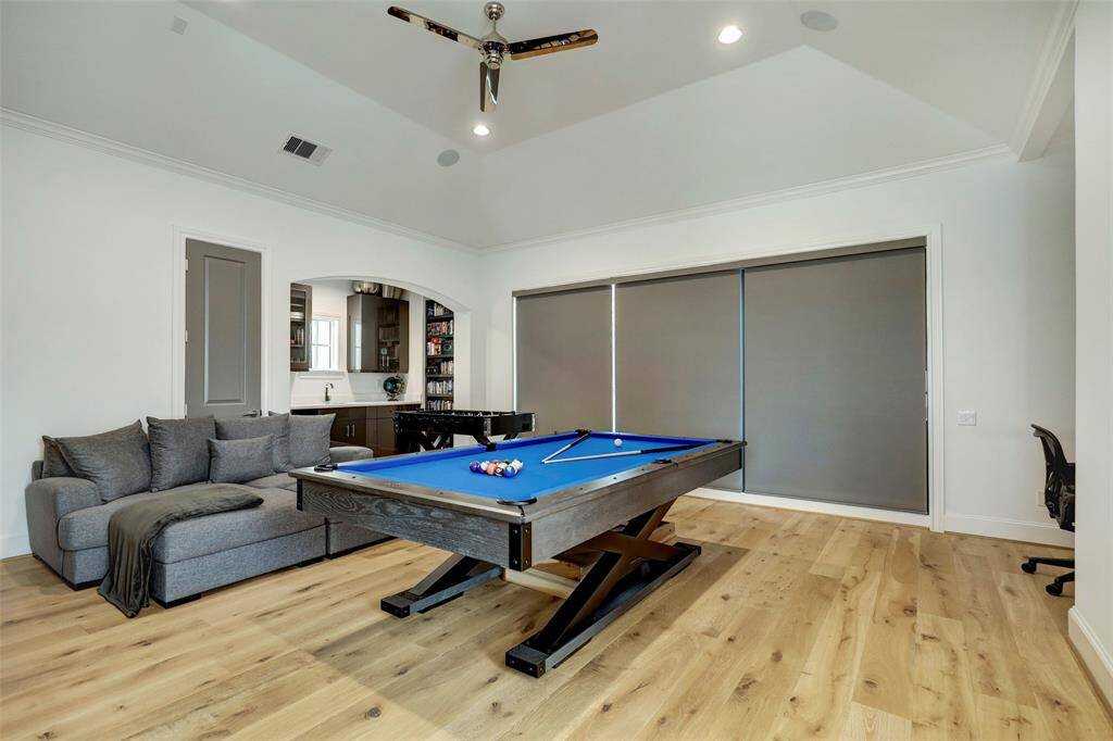 Another view of the Game room. Ceiling vaults to 12" and motorized blackout shades turn this space into the perfect home theater.