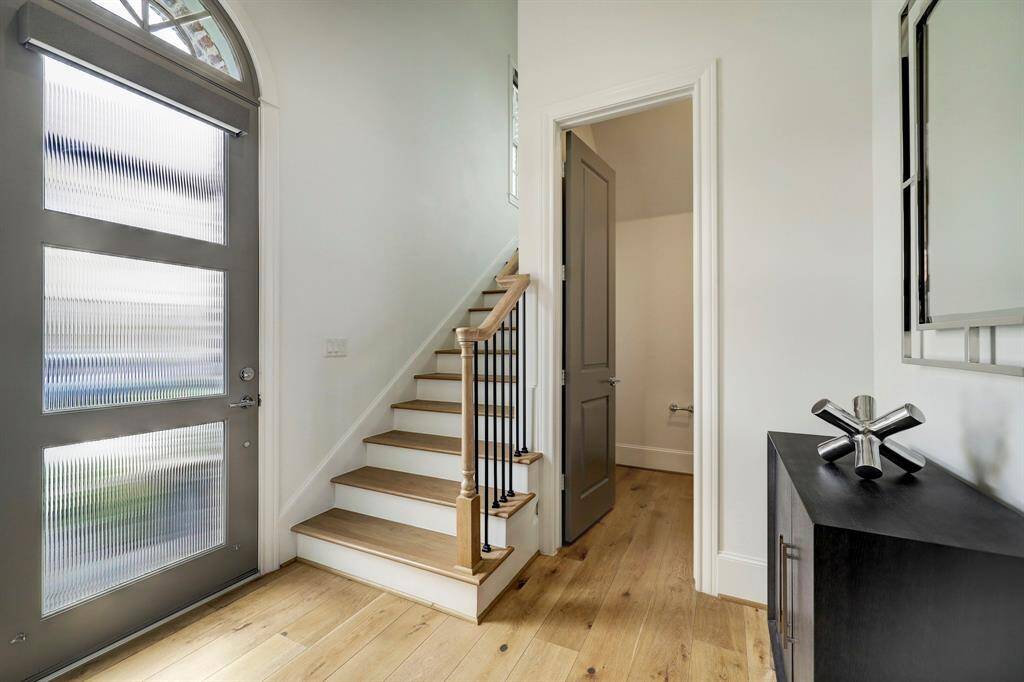 Enter into a large welcoming foyer. Reeded glass door allos light to filter in