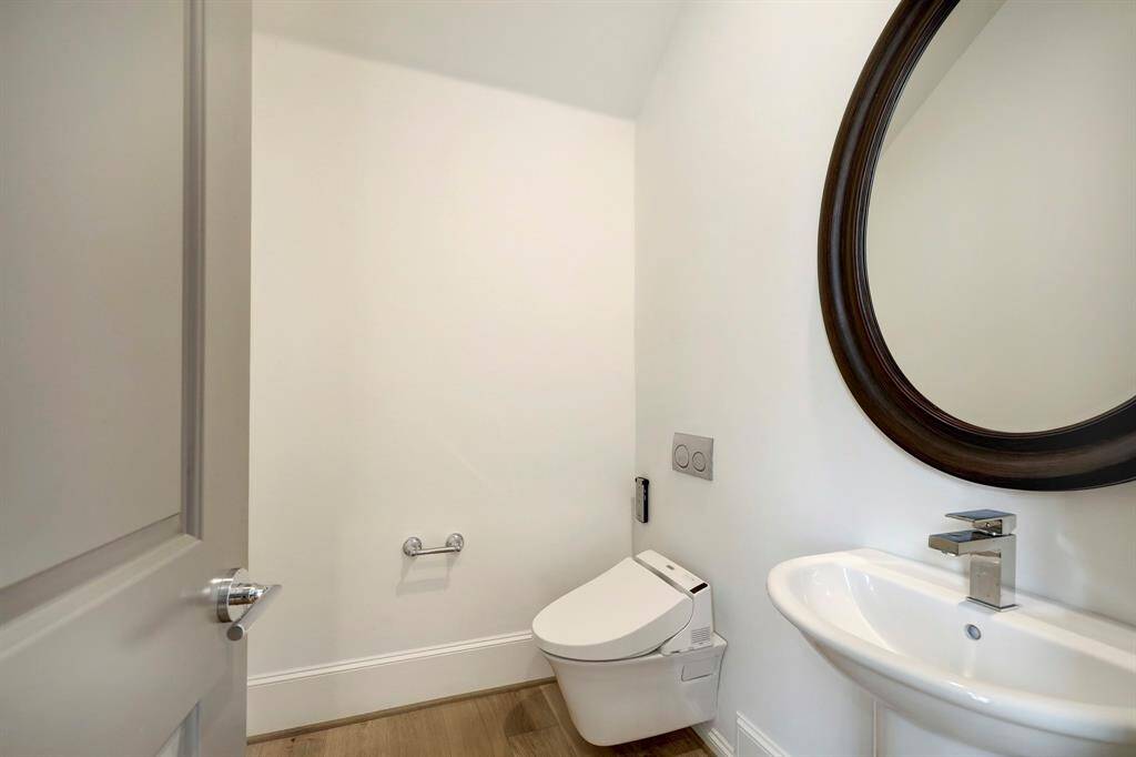 Powder bath boasts a wall-mounted Toto Washlet commode. Elegant and practiccal.