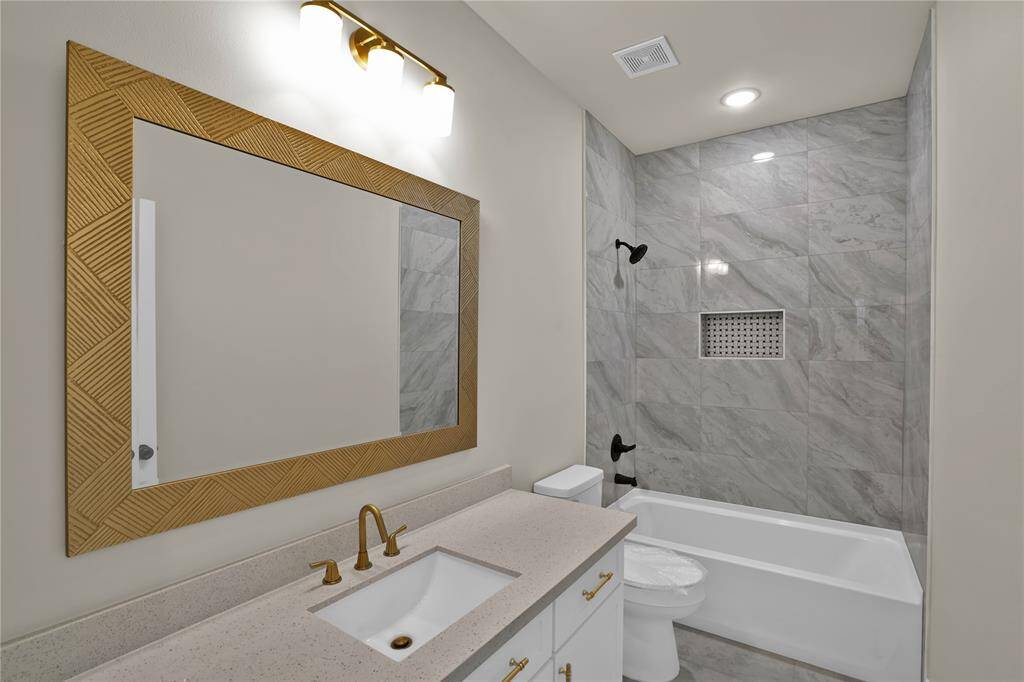 Conveniently located near the upstairs bedrooms, this stylish bathroom offers modern comfort and elegance.