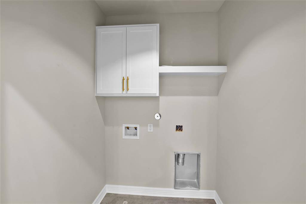 Convenient upstairs laundry room nestled between bedrooms for easy access.