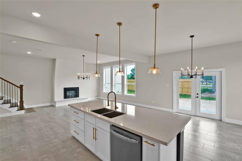 This inviting open-concept family space is beautifully illuminated with natural light.