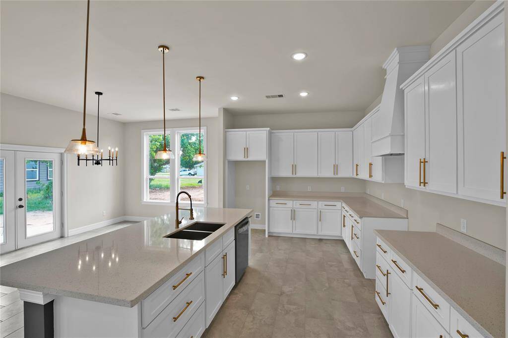 This kitchen offers ample counter space and an abundance of cabinets, perfect for all your culinary needs.