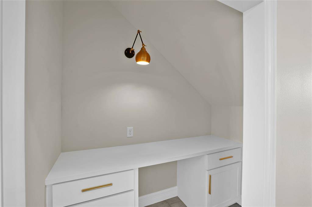 Charming under-staircase study nook, perfect for a cozy office space.