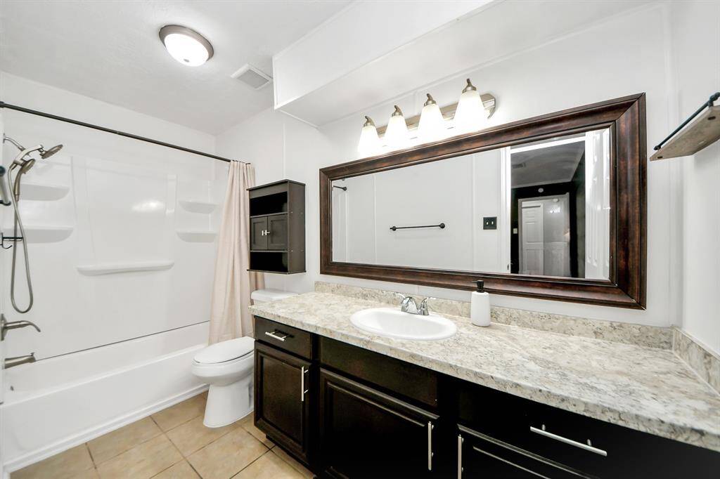 Primary Bathroom offers an extra long vanity and storage.