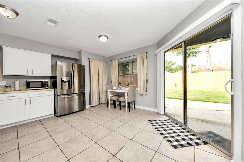 Kitchen offers plenty of cabinet space, along with a wall-in pantry.