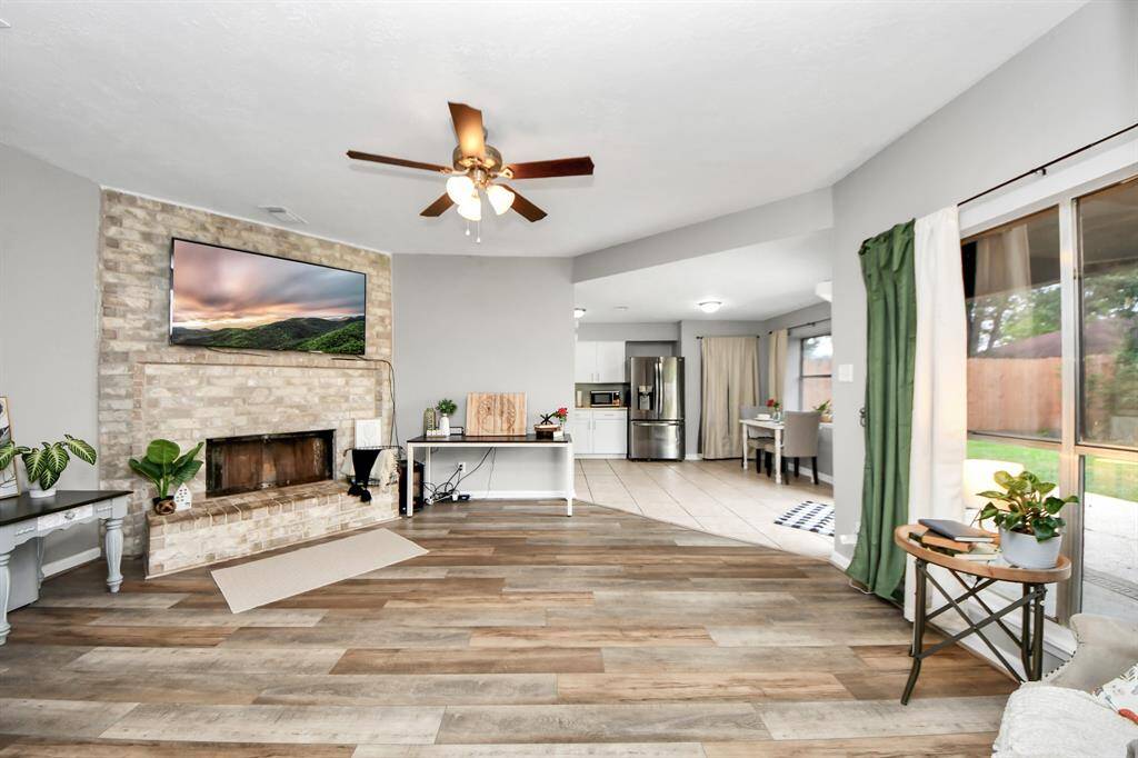 This open concept provides views into the kitchen and the backyard.