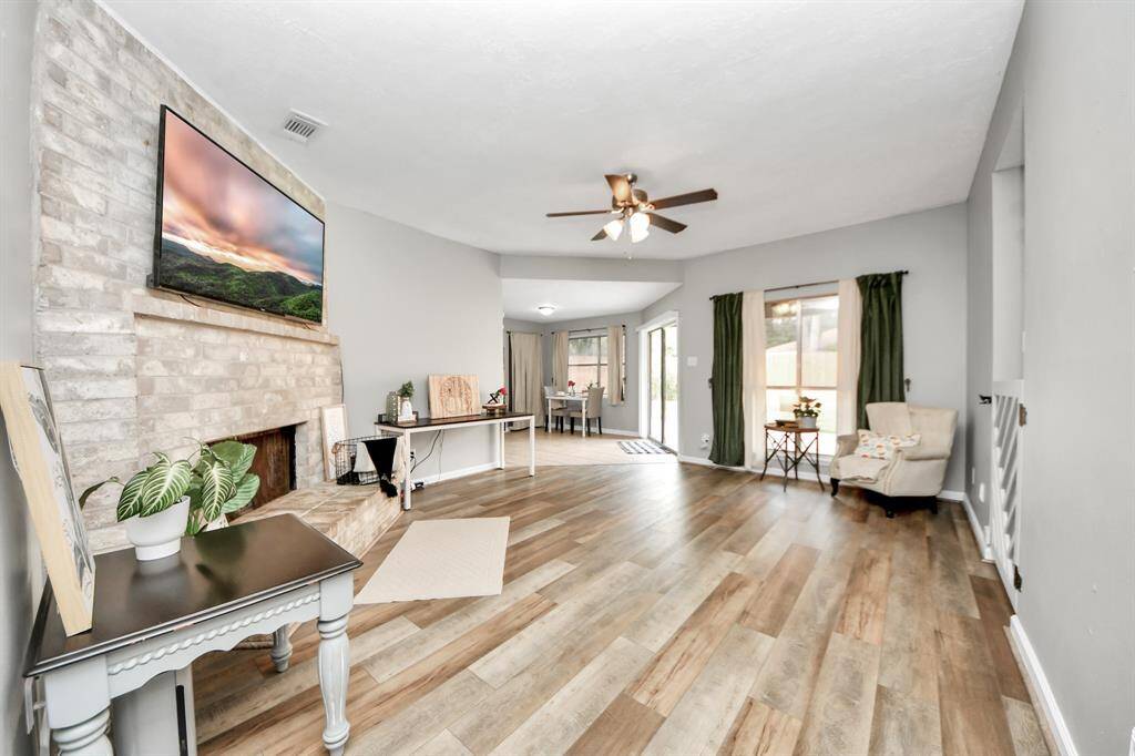 Beautiful NEW (2025) LVP flooring brings warmth to the living area along with the wood burning fireplace.