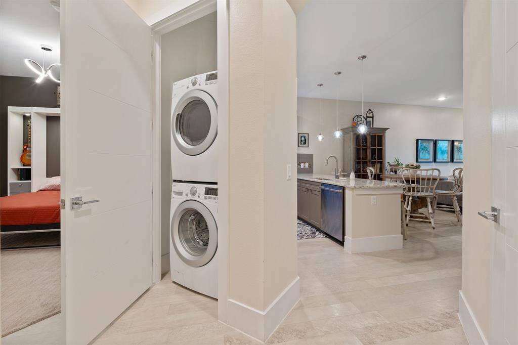 Stackable washer dryer to right of 2nd bedroom door.
