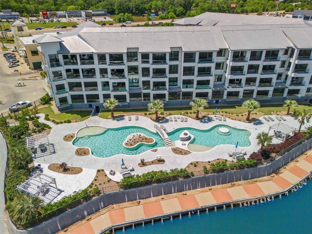 Shot of north/east facing side of building with resort like pool.