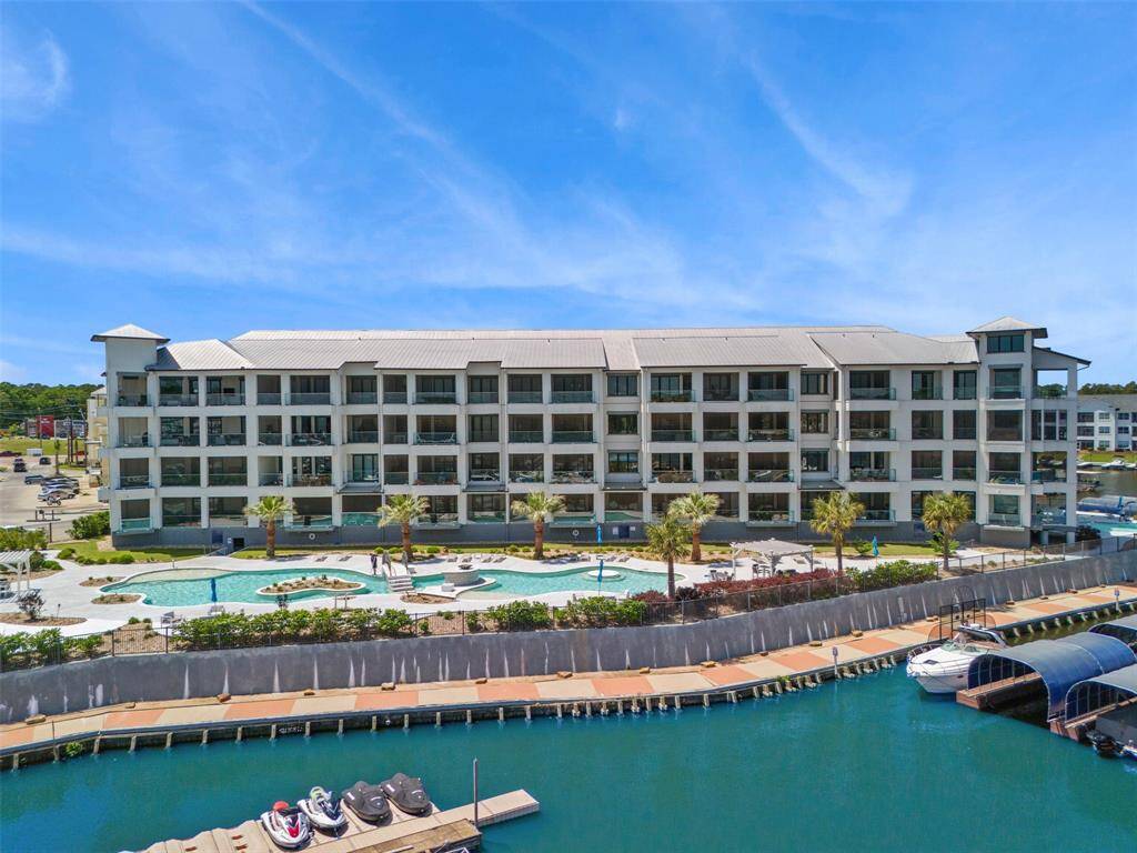 Shot of north/east facing side of building with resort like pool.