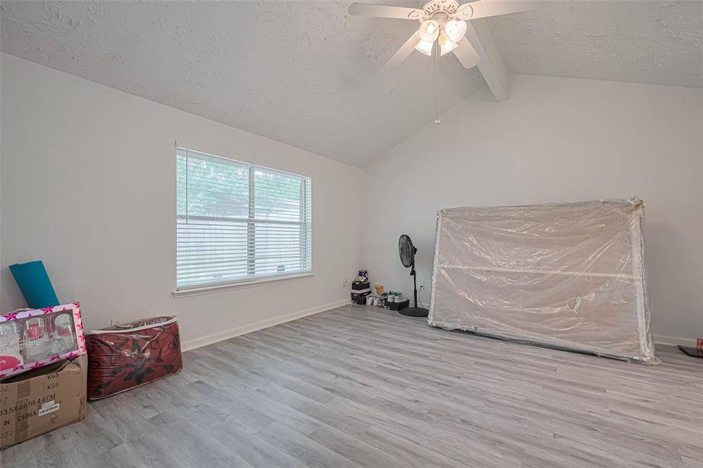 Primary bedroom has double windows and provides nice natural light.  Beamed cathedral ceiling is an additional special feature as well as flooring and lighting