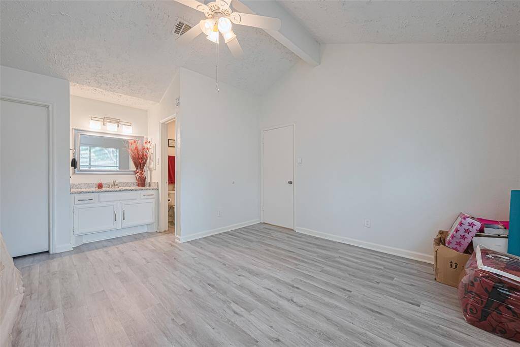 Primary bedroom toward door to hall and primary bath.  Walk-in closet at top left of photo