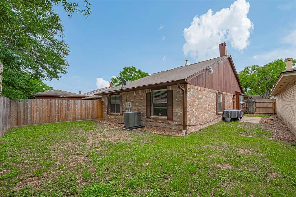 View of side and backyard.  Note patio which is accessed from living area