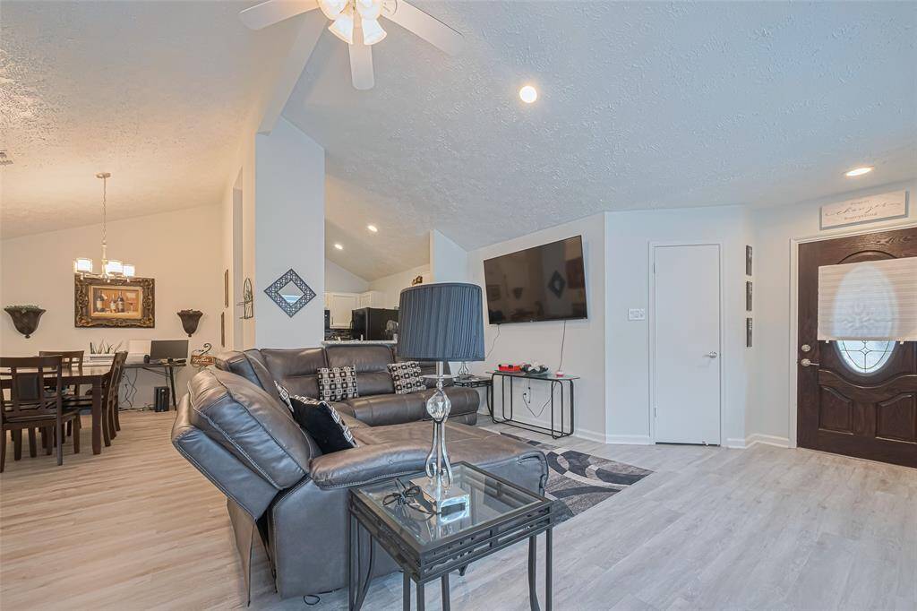 A better overall photo.  Notice the rooms architectural detail, thenlead glass front door, the closet door, and views into the dining room and kitchen from the living area.