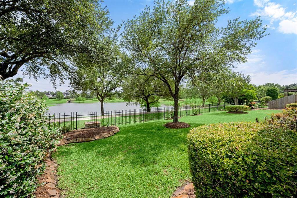 Enjoy the view of the Dove Manor Lake from this gorgeous backyard