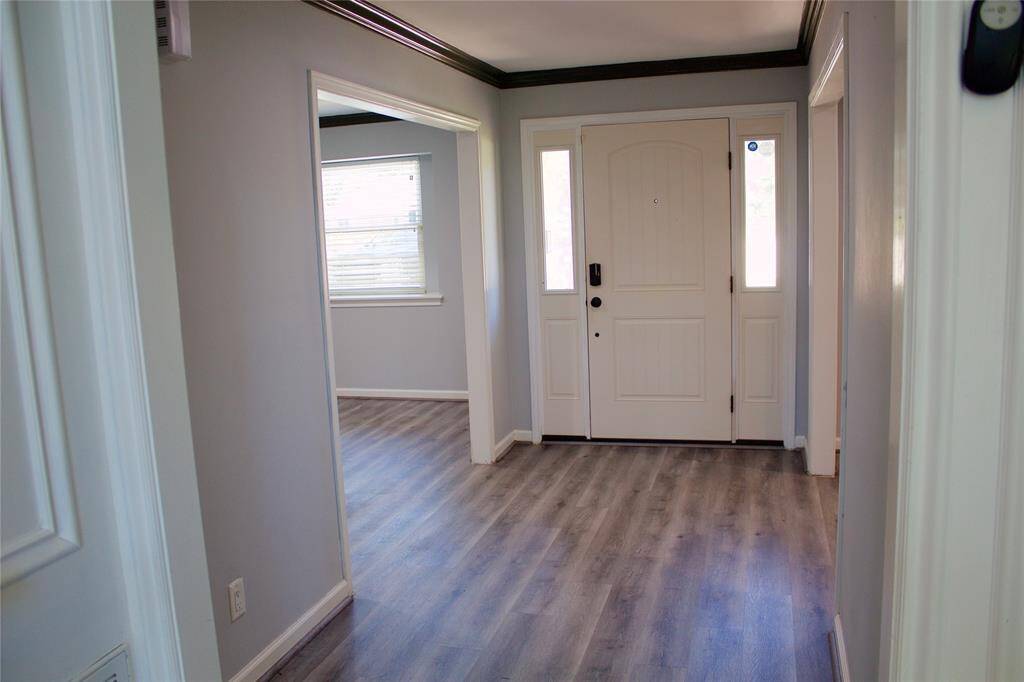 Welcoming entrance with modern flooring and abundant natural light.