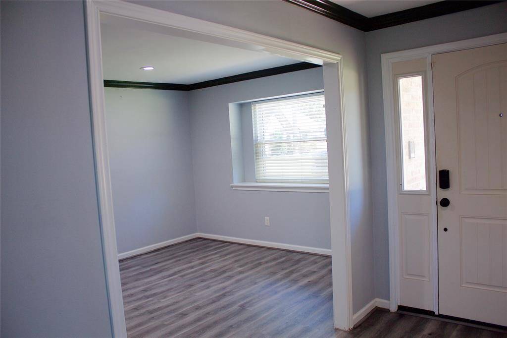 The formal dining area features a bay window that fills the space with natural light.
