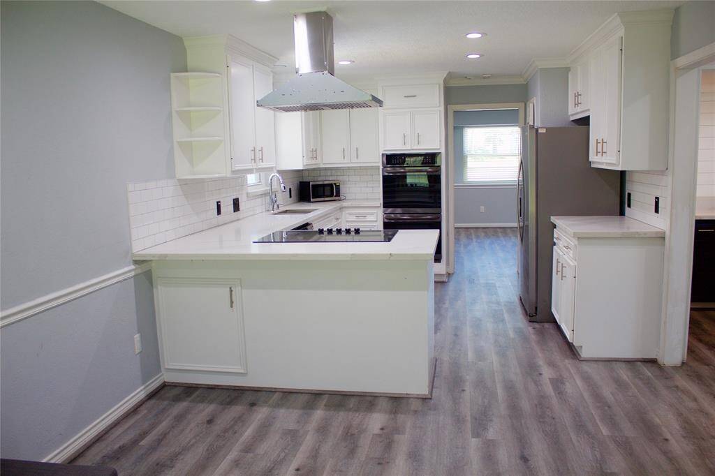 Experience the modern kitchen featuring a double oven and sleek stainless steel appliances.