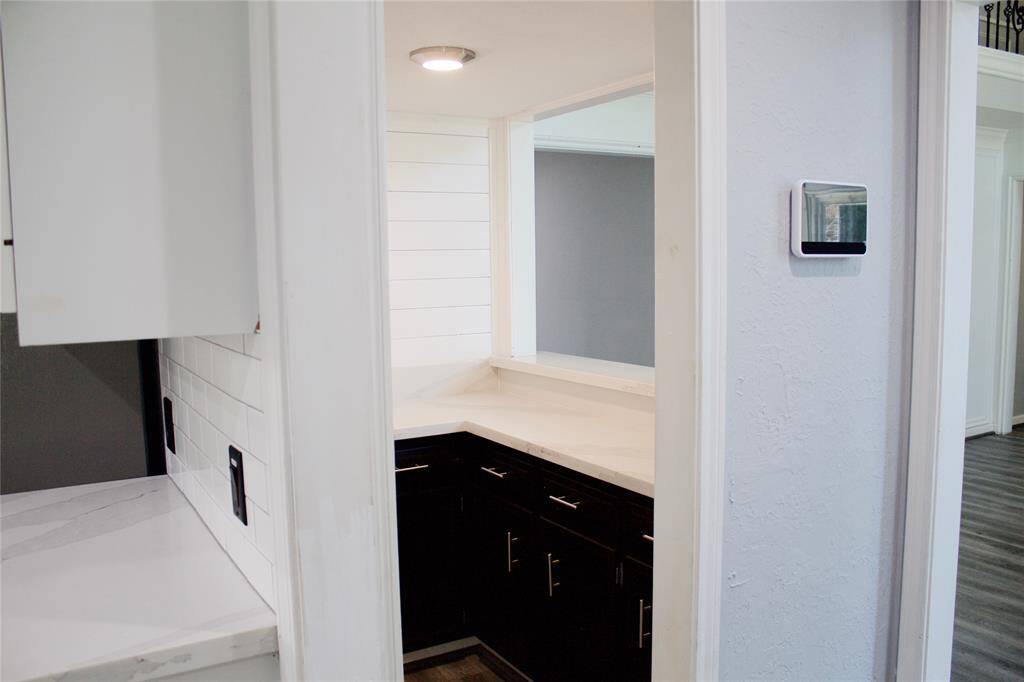 Discover the sleek, newly updated wet bar, perfect for entertaining guests.