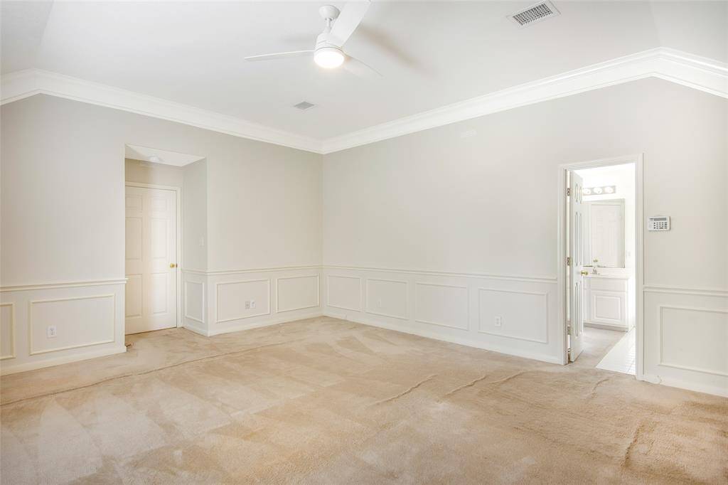 Primary Bedroom with Crown Molding, Ceiling Fan and decorative wall detail!