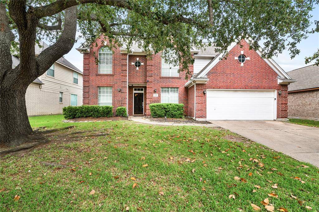 Charming curb appeal with a striking brick elevation, mature shade tree, and welcoming front entry—this home blends timeless architecture with a warm, inviting presence.