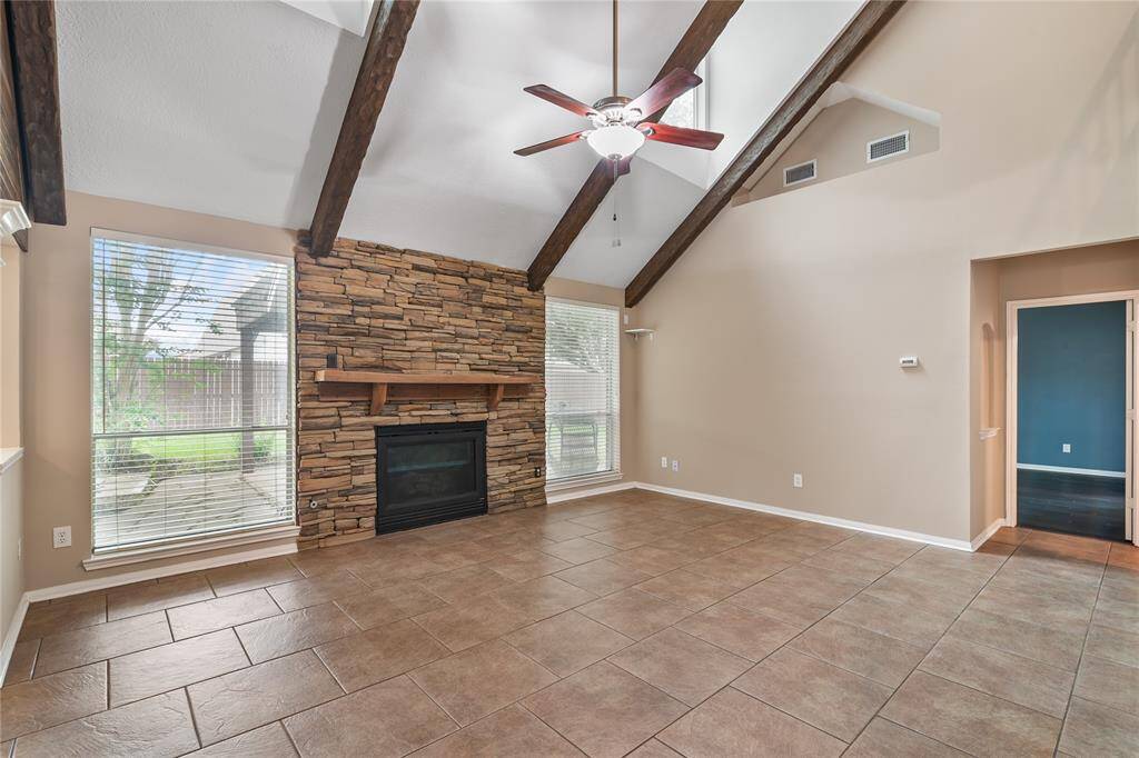 Sleek and spacious kitchen featuring granite countertops and modern long brushed nickel hardware—accented by crisp white cabinetry and a stylish tile backsplash.