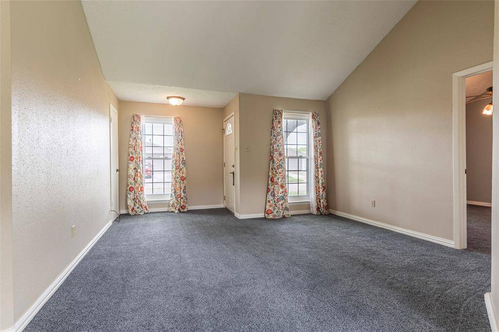 Living room view showing primary bedroom on right.