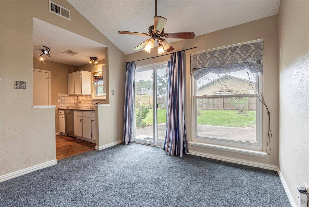 Dining area on right and kitchen on left with view to the large backyard.