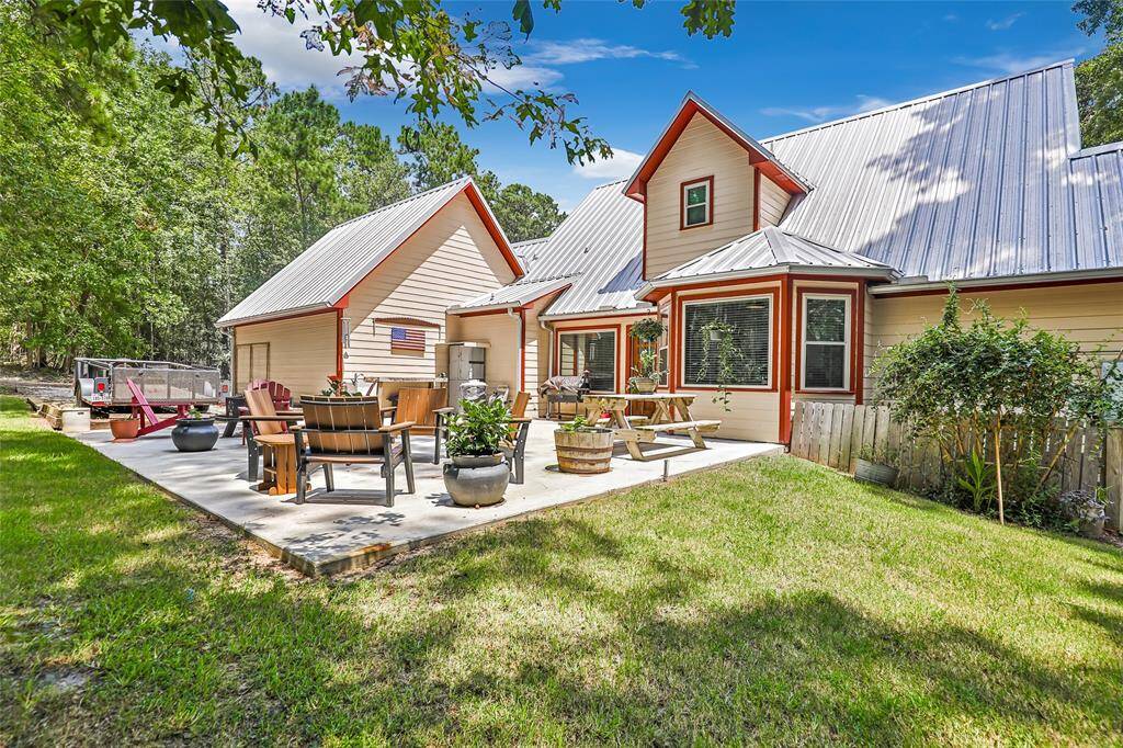Welcome to your backyard retreat! This spacious patio is perfect for entertaining or relaxing under the trees, with plenty of room for outdoor dining, cozy seating around the fire pit, and a peaceful wooded backdrop. Whether you're enjoying a quiet morning coffee or hosting a weekend BBQ, this outdoor space is ready to make memories.