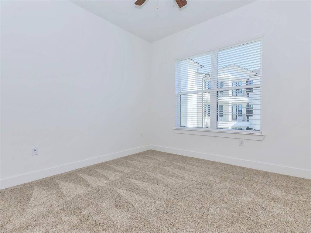 Primary bedroom with large window and ensuite bath