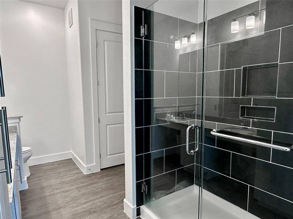 Large L-shaped bathroom with walk-in shower
