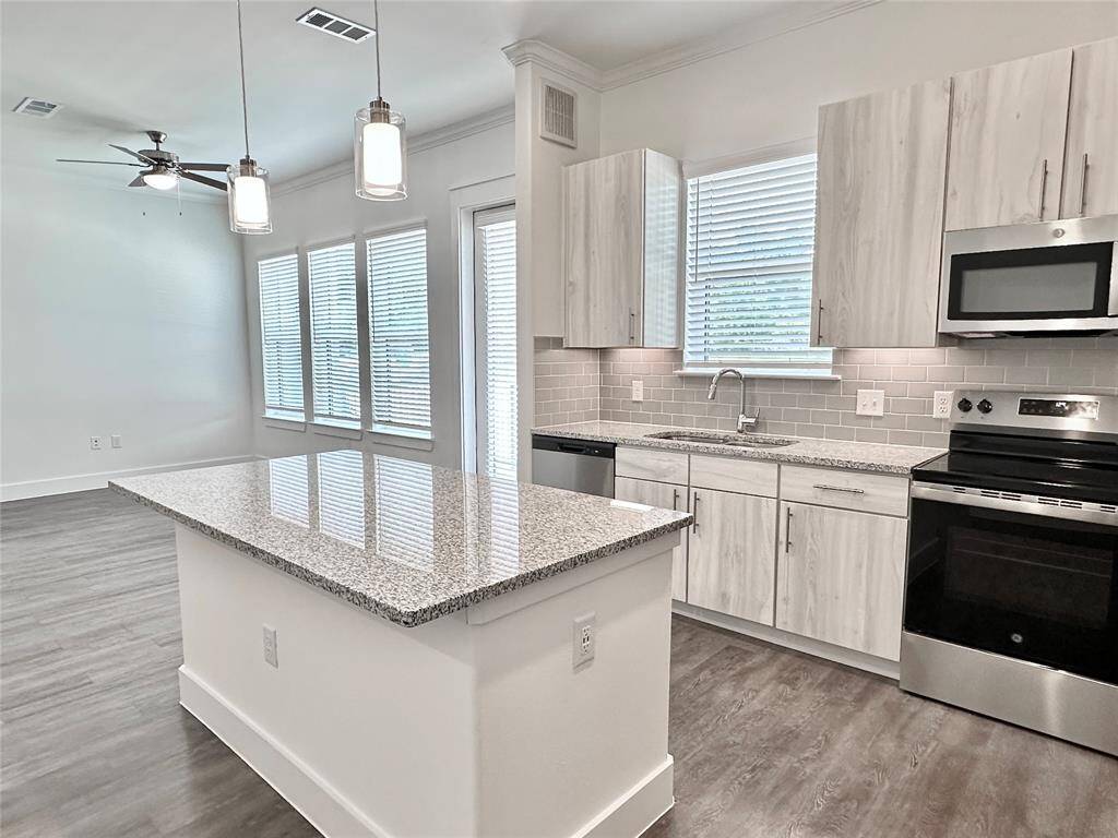 Kitchen with granite countertops, soft-close drawers, under-cabinet lighting, and SS appliances