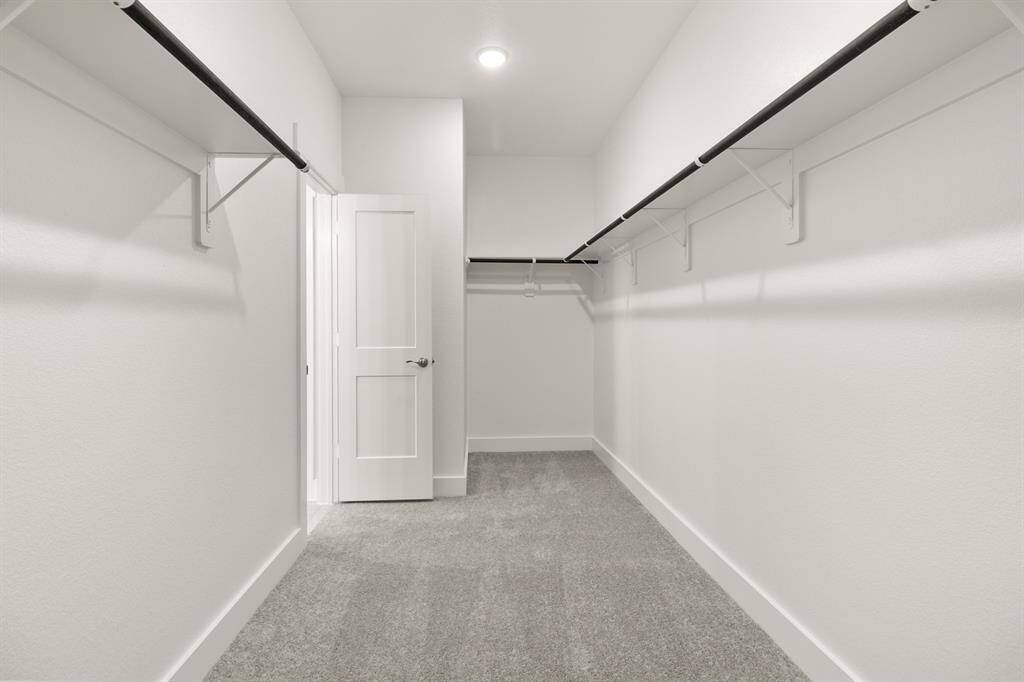 This closet is a perfect blank canvas to design a custom closet with ample hanging space, perfectly organized drawers, and chic shoe racks come together seamlessly, ensuring that everything has its place.