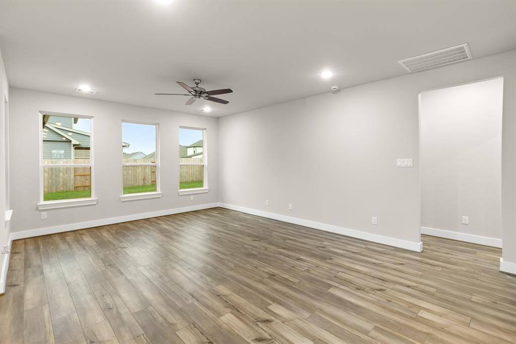 The abundance of windows not only brightens the space but also brings the outdoors in, making the whole area feel airy, warm, and full of life.