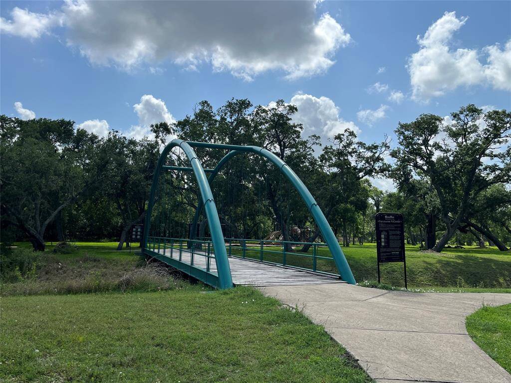 The bridge leads to the playground, exercise areas, and there's a nice path to the fishing pier on Bastrop Bayou.